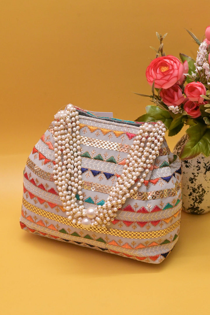 Ash Color Potli Clutch with Embroidery and Pearl Handle